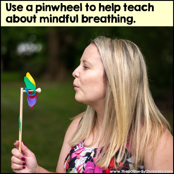 Kris from Pathway 2 Success blowing a pinwheel outside